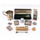A mixed lot comprising a silver compact, a silver christening mug, a 1976 Christmas spoon by John