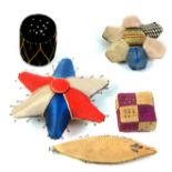 Five good pin cushions comprising three silk patchwork examples, a star, 8cm, another 5cm, a square,