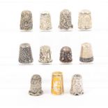 Eleven silver and white metal thimbles comprising three Indian, one holed, six Thai and two Greek (