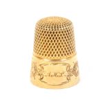 An American gold thimble the frieze with engraved panels and an oval cartouche initialled 'A.H.P.'