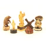 Five novelty celluloid tape measures comprising a windmill, a bear, a standing dog in suit and