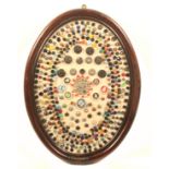 Buttons - costume and dress - three framed displays comprising an oval frame with a large selection,