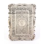 A Victorian silver card case of shaped rectangular outline, hinged lid, all over engraved decoration