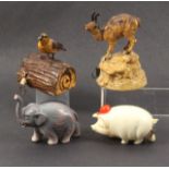 Four novelty celluloid tape measures comprising an elephant, a pig wearing a red hat, a bird on log,