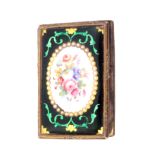 A needlebook, the gilt brass framed covers enclosing enamel panels one with a reserved oval of