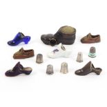 Thimble stands and thimbles comprising a blue glass thimble shoe, 6cm, another embroidered velvet,