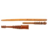 Three wooden spindle form knitting sticks comprising a long example with bands of geometric