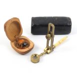 An early 19th Century simple microscope and a death bug, the brass microscope with hinged lens and