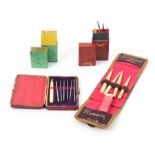 Three crochet sets and a similar box comprising a red leather rectangular case 'Crochet' in gilt,