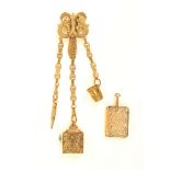 A Victorian Brass chatelaine, pierced leaf form clip with three floral chains to a pencil, a tape