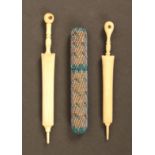 Three needle cases comprising two bone examples in the form of furled umbrellas, each with
