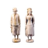 Two Dieppe 19th Century carved ivory figural needle cases one in the form of a male fisherman in