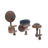 Three wooden clamps comprising a turned hard wood example with circular pin cushion top, 16cm, a