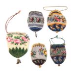 Five small format 19th Century beadwork purses two draw string examples, both floral decoration, and