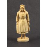 A good Dieppe carved ivory figural needle case in the form of a standing fisher woman in traditional
