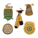 Five 19th Century small format purses comprising a yellow and black stocking form example with