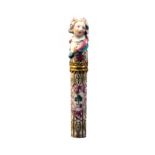 A fine French porcelain cylinder bodkin case, circa 1780, the upper section as a woman in bonnet the