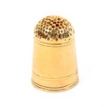 A gold thimble with line decoration and initialled