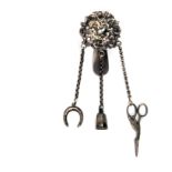 A silver chatelaine for a doll, the clip with scroll pierced mount to three chains with horseshoe,