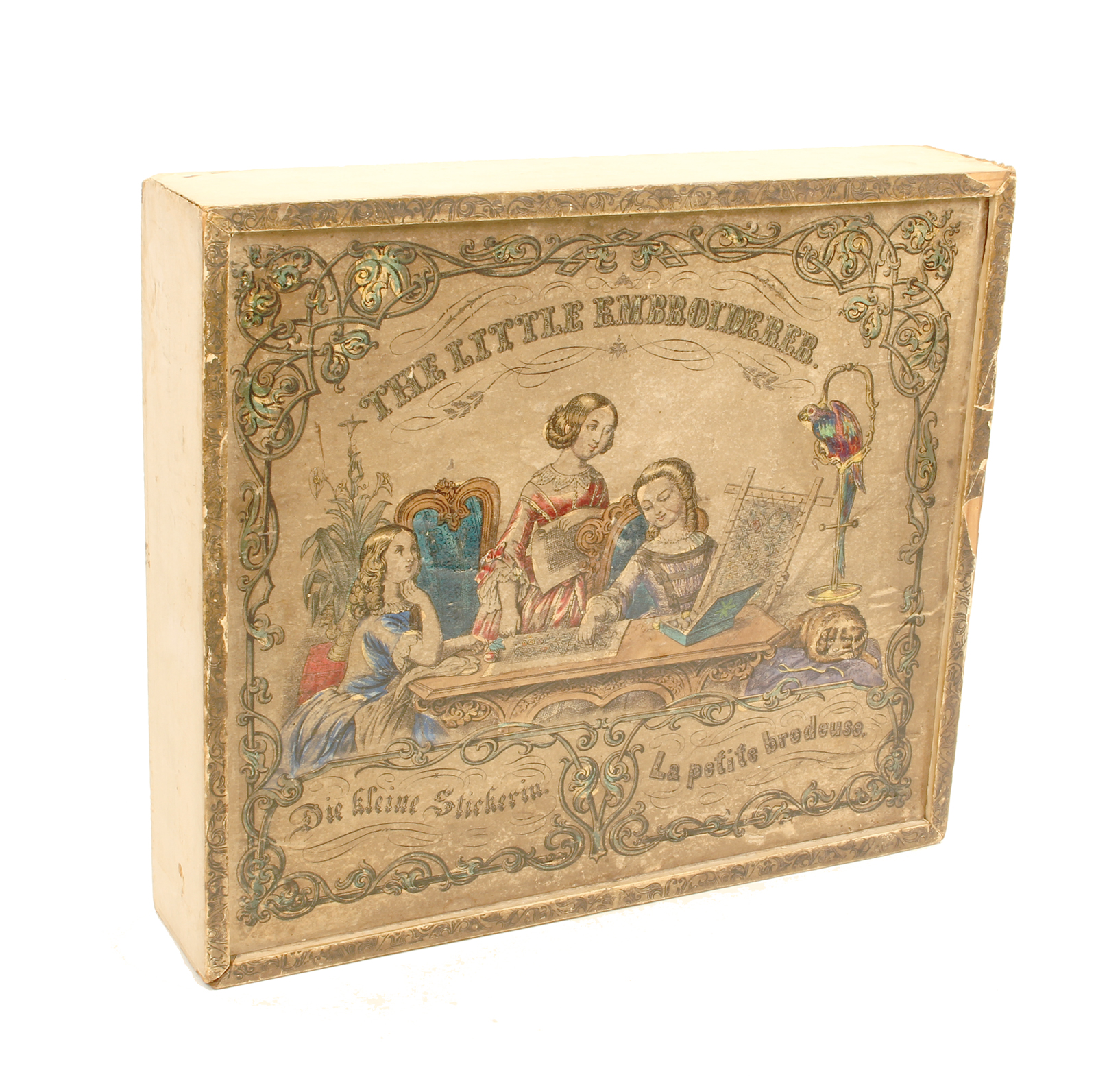 A late 19th century child's embroidery frame in paper covered rectangular box the frame complete