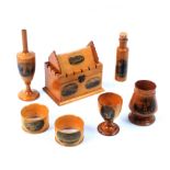 Mauchline ware - seven pieces - a crenalated rectangular box with pitched roof (Llandudno Bay/From