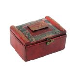 A rare Regency red leather needle packet box of rectangular form the hinged lid with raised tablet