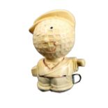 A celluloid novelty tape measure in the form of a golfer the head as a golf ball, the tape printed