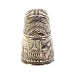 A commemorative silver thimble circa 1810 the frieze depicting the Brighton Pavilion, one hole to