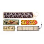 Five cloth needle rolls and purses comprising a leaf decorated example in white bead work,