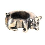 A silver pin cushion in the form of a pig at rest, velvet pad, Chester 1945, makers mark indistinct,