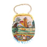 A 19th Century beadwork bag worked with buildings and figures in landscapes over flowers and a