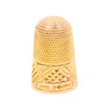 A 9ct gold thimble by Henry Griffiths and Sons, Chester 1894, engraved and cut frieze