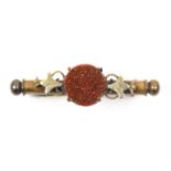 A nanny brooch, gold circular spangle in scroll mount stamped 'DRGM 218036', 5cm