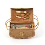 A rare miniature sewing companion for a doll of shaped bag form in diced leather with twin
