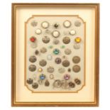 Buttons - dress and costume - four framed displays comprising a framed display of 77 mostly engraved