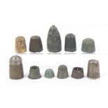 Eleven thimbles mostly excavated and of early date in copper brass and bronze and a brass thimble