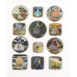 Twelve vintage powder compacts all brightly coloured elegant ladies, ships, birds, five circular,