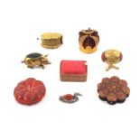 Eight pin cushions comprising an oval pierced gilt example, 3.5cm, a coronation crown, a gilt