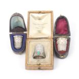 Three silver thimbles each in a leather case comprising a continental example with polished stone