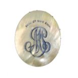 A French mother of pearl and disc form pin cushion engraved and highlighted in blue to one side '