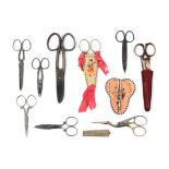 A collection of scissors including two button holing pairs, one in sheath, a pair in Chinese