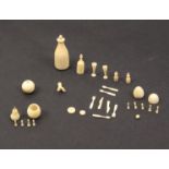 A collection of miniature ivory objects comprising a pear containing further miniature pieces, a