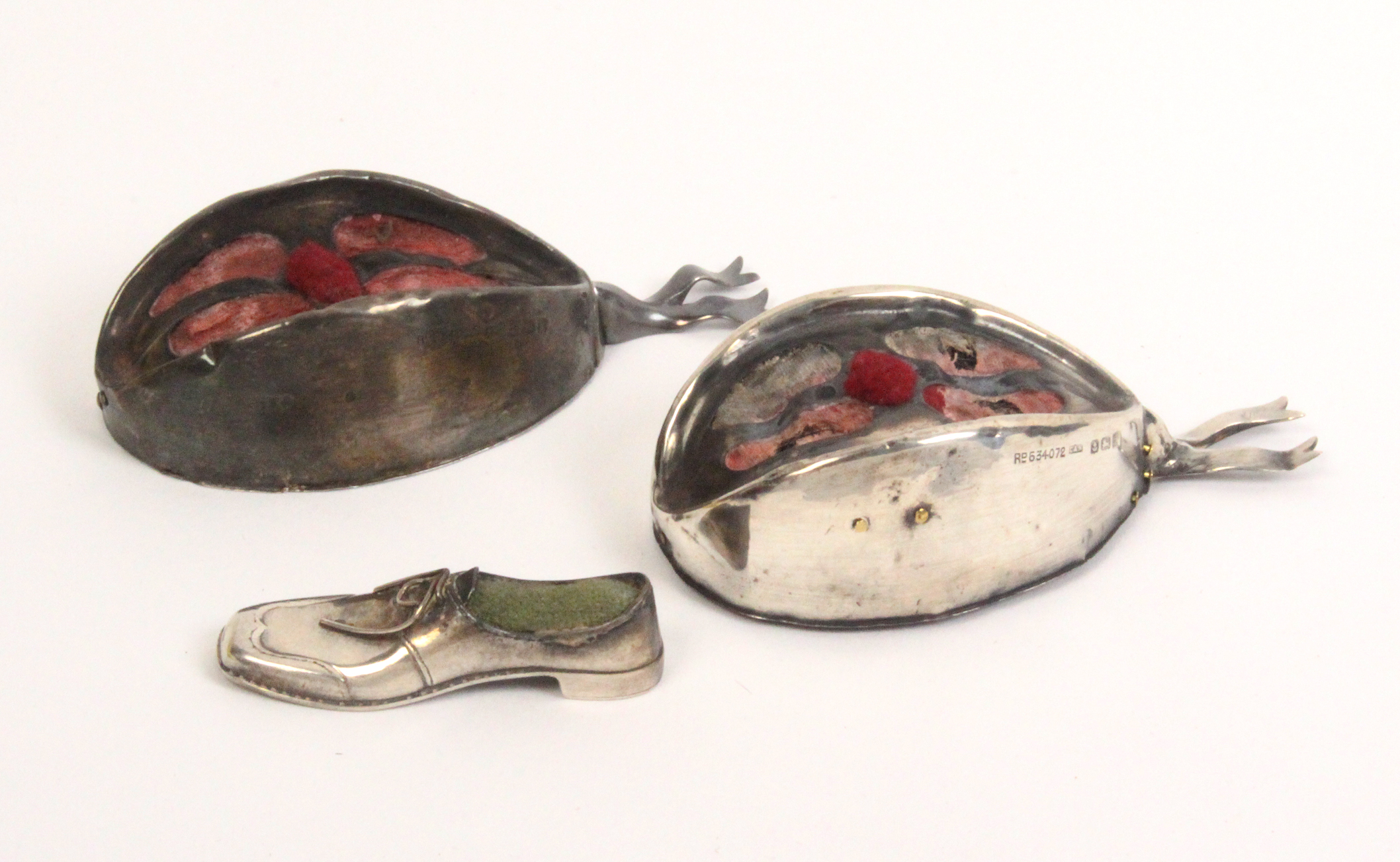 Three silver pin cushions comprising two in the form of glengarry's, Birmingham, 1909, 10cm and