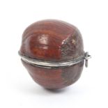 A rare etui for a doll contained in a natural hazel nut, circa 1850, with ring suspension, silver