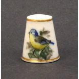 A Royal Worcester porcelain puce mark thimble painted with a blue tit and ivy leaves, unsigned