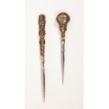Two stilettos, one with silver gilt handle in the form of a quiver of arrows, 8.7cm, the other