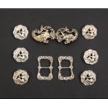 Buttons and Buckles in silver comprising a set of six petal form buttons each with a seated female