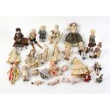 Twenty-two Victorian and later small format dolls mostly ceramic, two ceramic heads, a doll on skis,