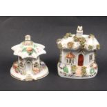 Two 19th Century Staffordshire ceramic pastille burners each modelled as a cottage with flowers, the