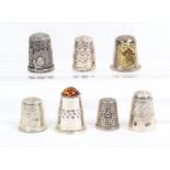 Seven modern English silver thimbles including a stone top, a Guernsey commemorative, another for